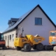 Heavy plant machinery, including a Doosan crawler excavator, Hitachi mini digger, and Thwaites dumpers on a residential construction site by a premier plant hire company in Dublin.