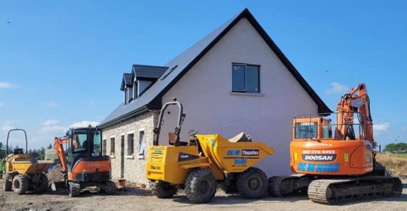 Heavy plant machinery, including a Doosan crawler excavator, Hitachi mini digger, and Thwaites dumpers on a residential construction site by a premier plant hire company in Dublin.